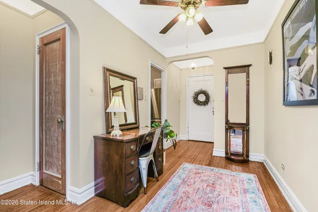 a view of a hallway to a livingroom with furniture