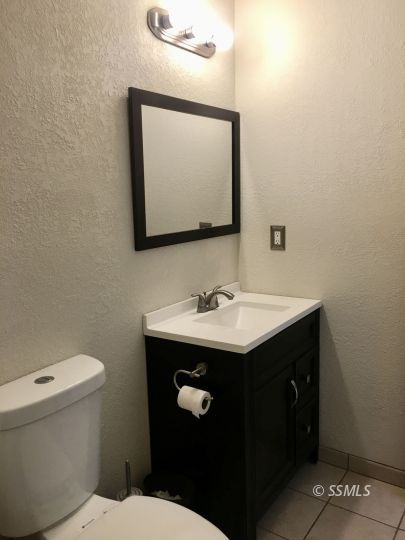 509 South Helena Street Ridgecrest, CA 93555 - Photo 15 of 40 a bathroom with a toilet sink and mirror