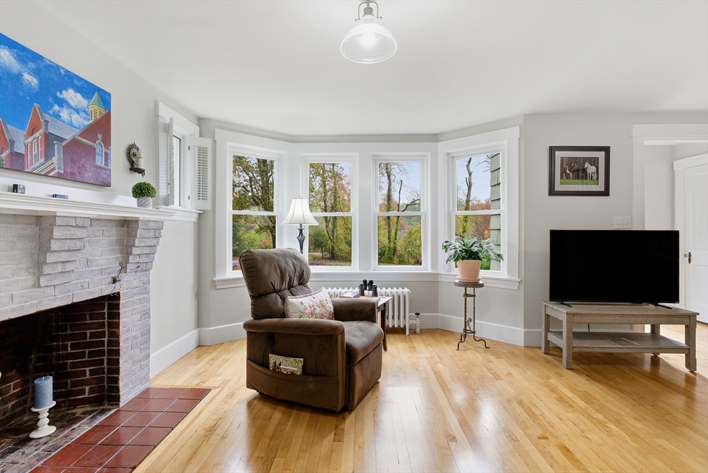 295 Vaughn Hill Road Bolton, MA 01740 - Photo 19 of 38 a living room with furniture and a flat screen tv