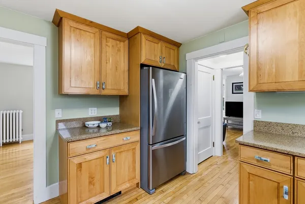a kitchen with stainless steel appliances granite countertop a refrigerator sink and stove