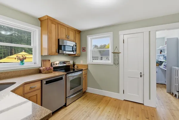 a kitchen with stainless steel appliances granite countertop a stove a sink and a refrigerator