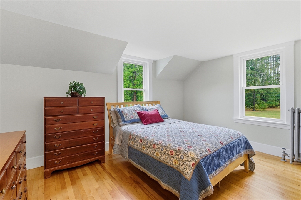 295 Vaughn Hill Road Bolton, MA 01740 - Photo 27 of 38 a bedroom with a bed and a dresser