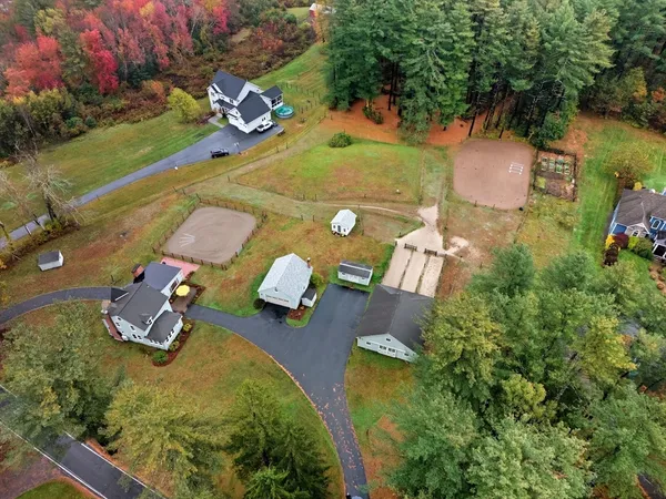 an aerial view of a house with yard