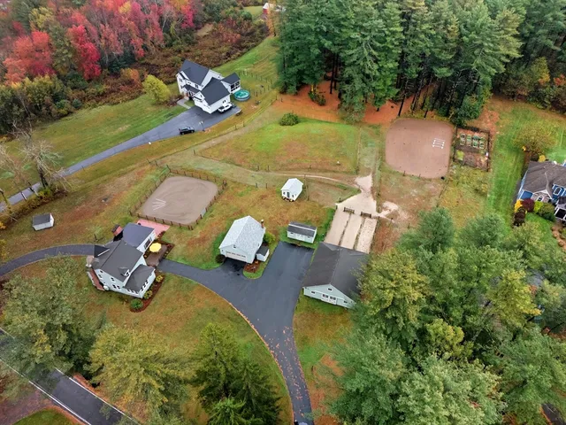 an aerial view of a house with yard basket ball court and outdoor seating