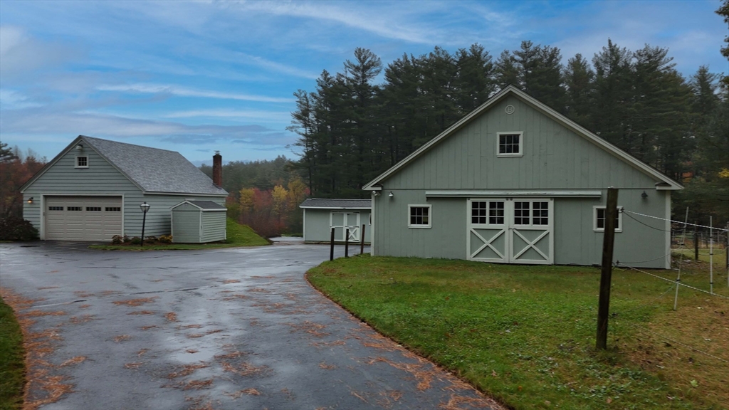 295 Vaughn Hill Road Bolton, MA 01740 - Photo 6 of 38 a view of a house with a yard plants and large tree
