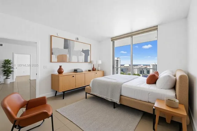 a bedroom with a bed and a couch