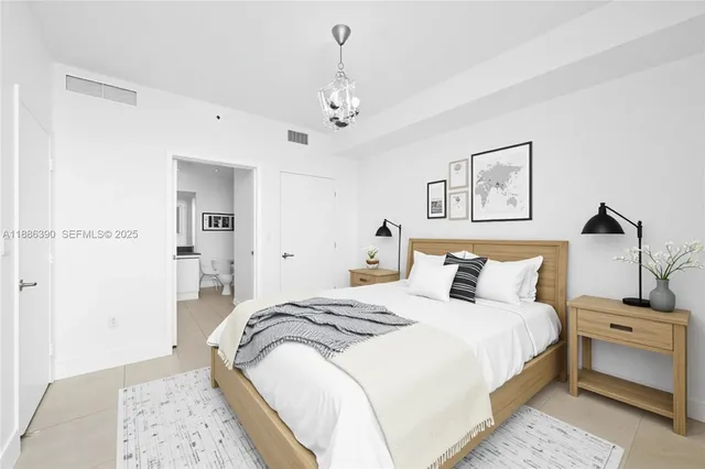 a bedroom with bed and a chandelier