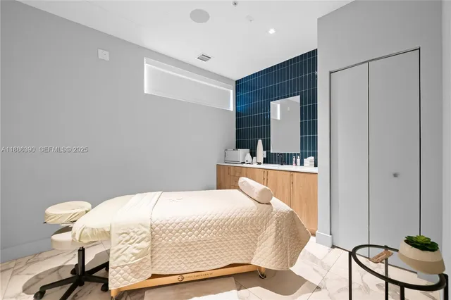 a bedroom with a bed and chair