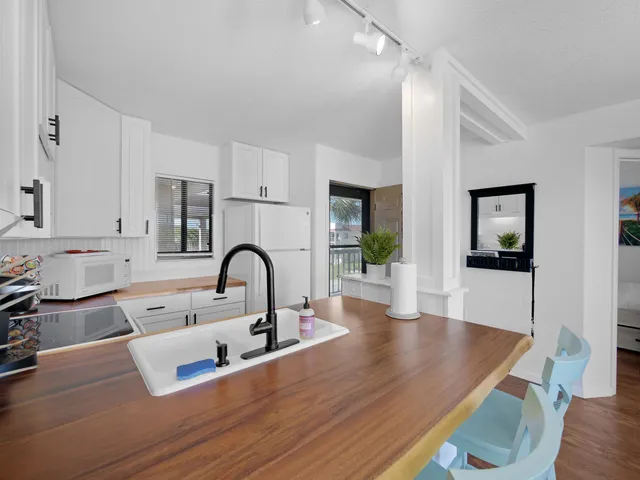 a kitchen with kitchen island a sink stove and wooden floor