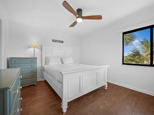 a bedroom with a bed and a painting on the wall