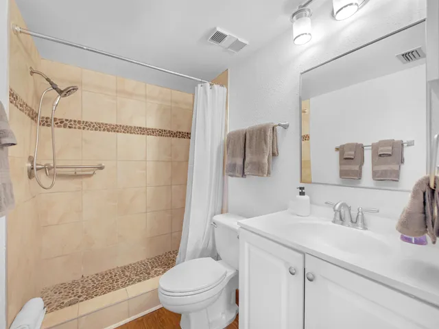 a bathroom with a sink toilet and shower