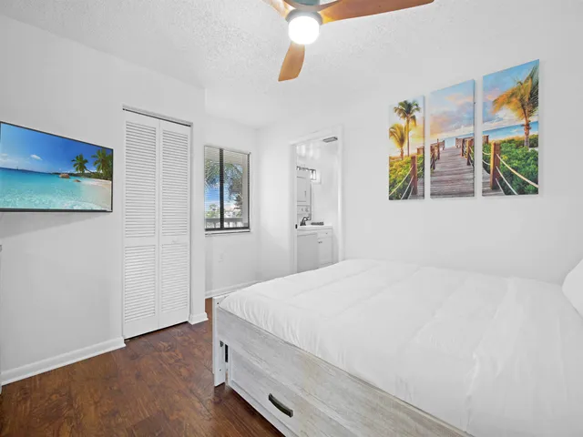 a bedroom with a bed and a painting on the wall