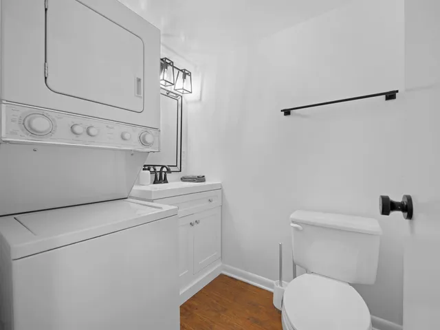 a bathroom with a toilet a sink and a mirror