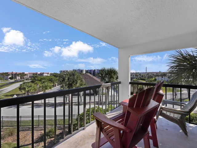 a view of a chairs and table in the balcony