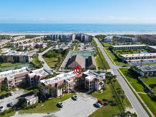 a view of a house with a backyard porch and sitting area