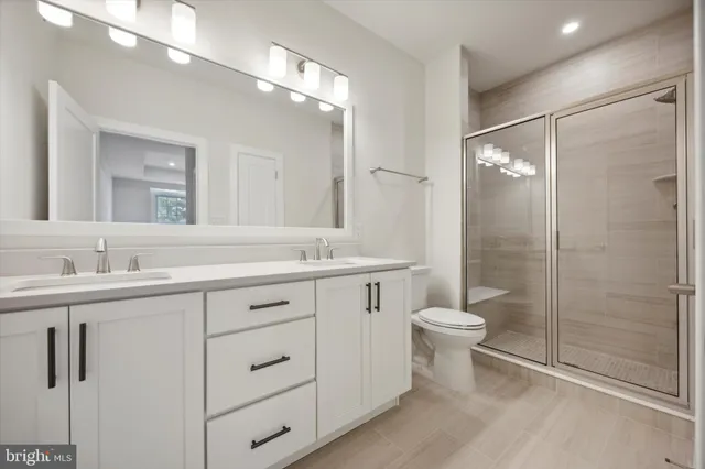 a bathroom with a toilet sink and shower