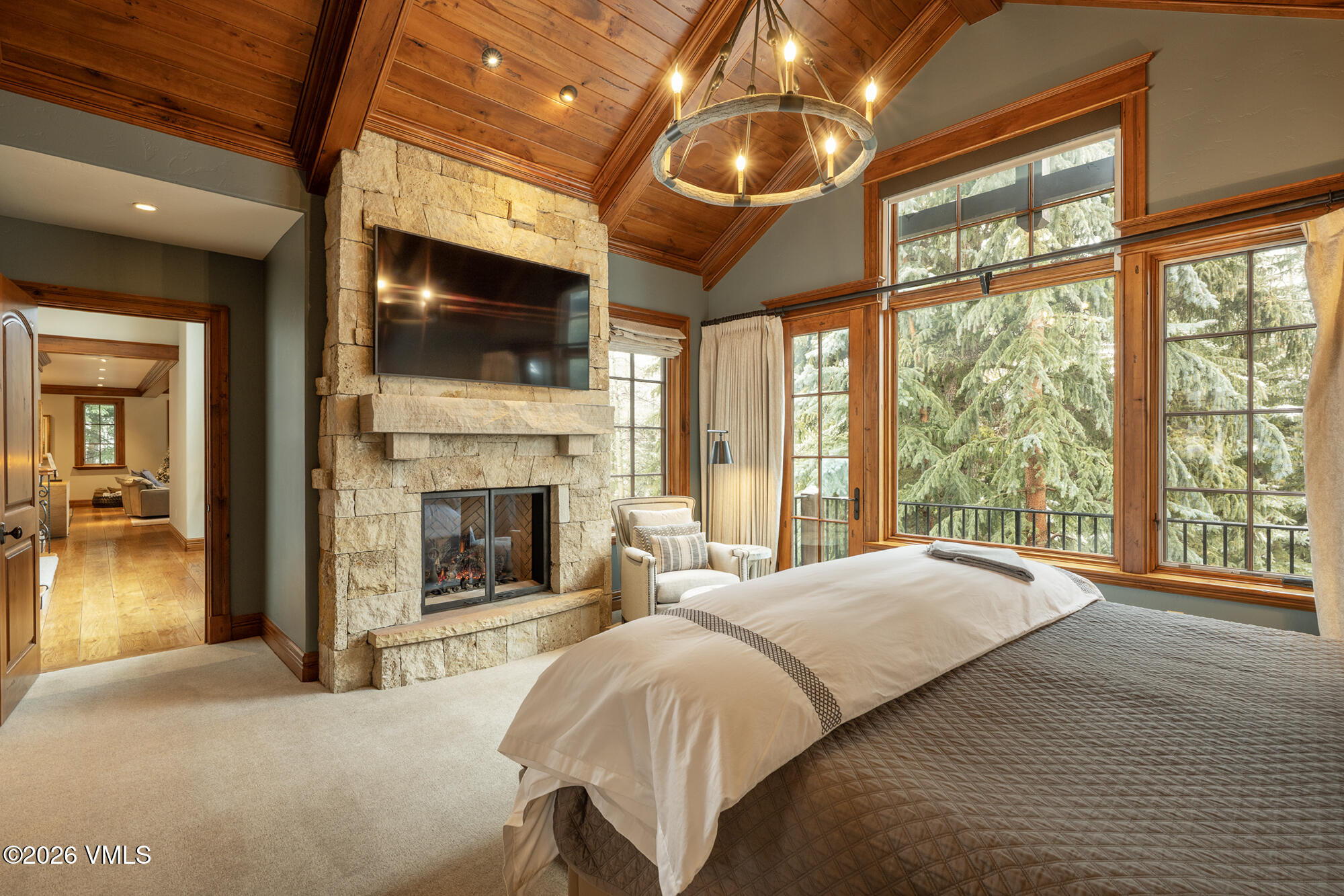 325 West Forest Road Vail, CO 81657 - Photo 11 of 33 a spacious bedroom with a large bed and a fireplace