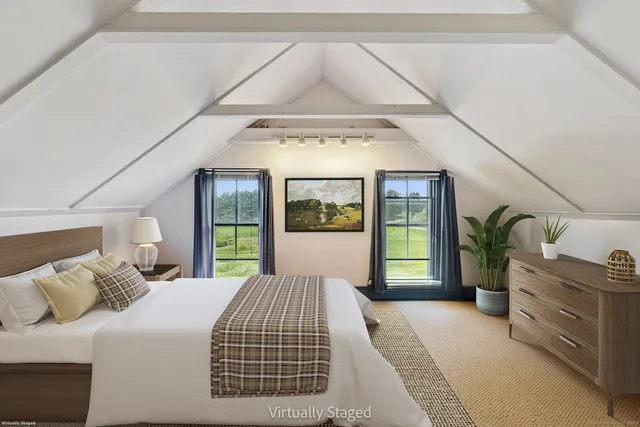 a bedroom with a large bed and a window