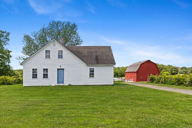 a front view of house with yard and green space