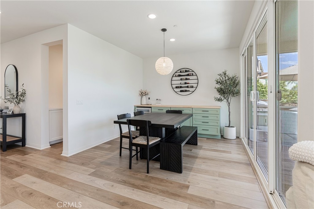 32067 Dawning Ridge Temecula, CA 92591 - Photo 12 of 73 a view of a dining room and livingroom with furniture wooden floor and a rug