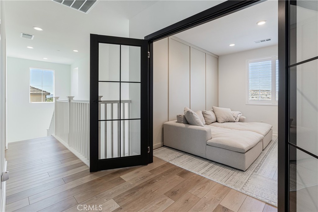 32067 Dawning Ridge Temecula, CA 92591 - Photo 29 of 73 a living room with furniture and wooden floor