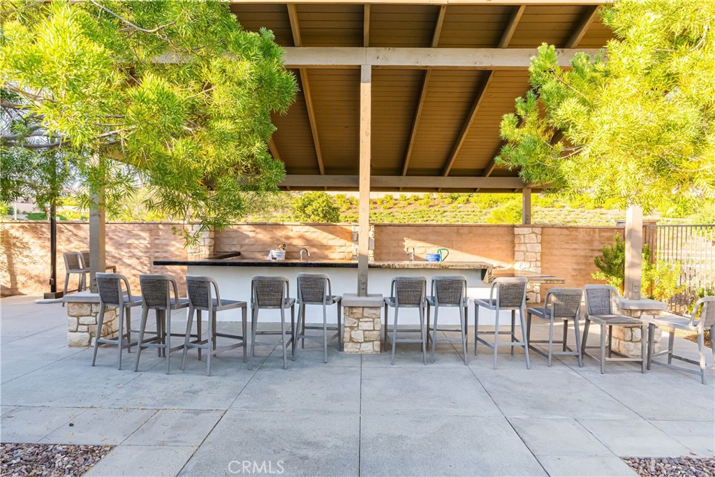 32067 Dawning Ridge Temecula, CA 92591 - Photo 58 of 73 a view of a patio with table and chairs and potted plants