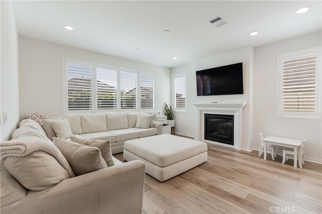 32067 Dawning Ridge Temecula, CA 92591 - Photo 6 of 73 a living room with furniture a flat screen tv and a fireplace