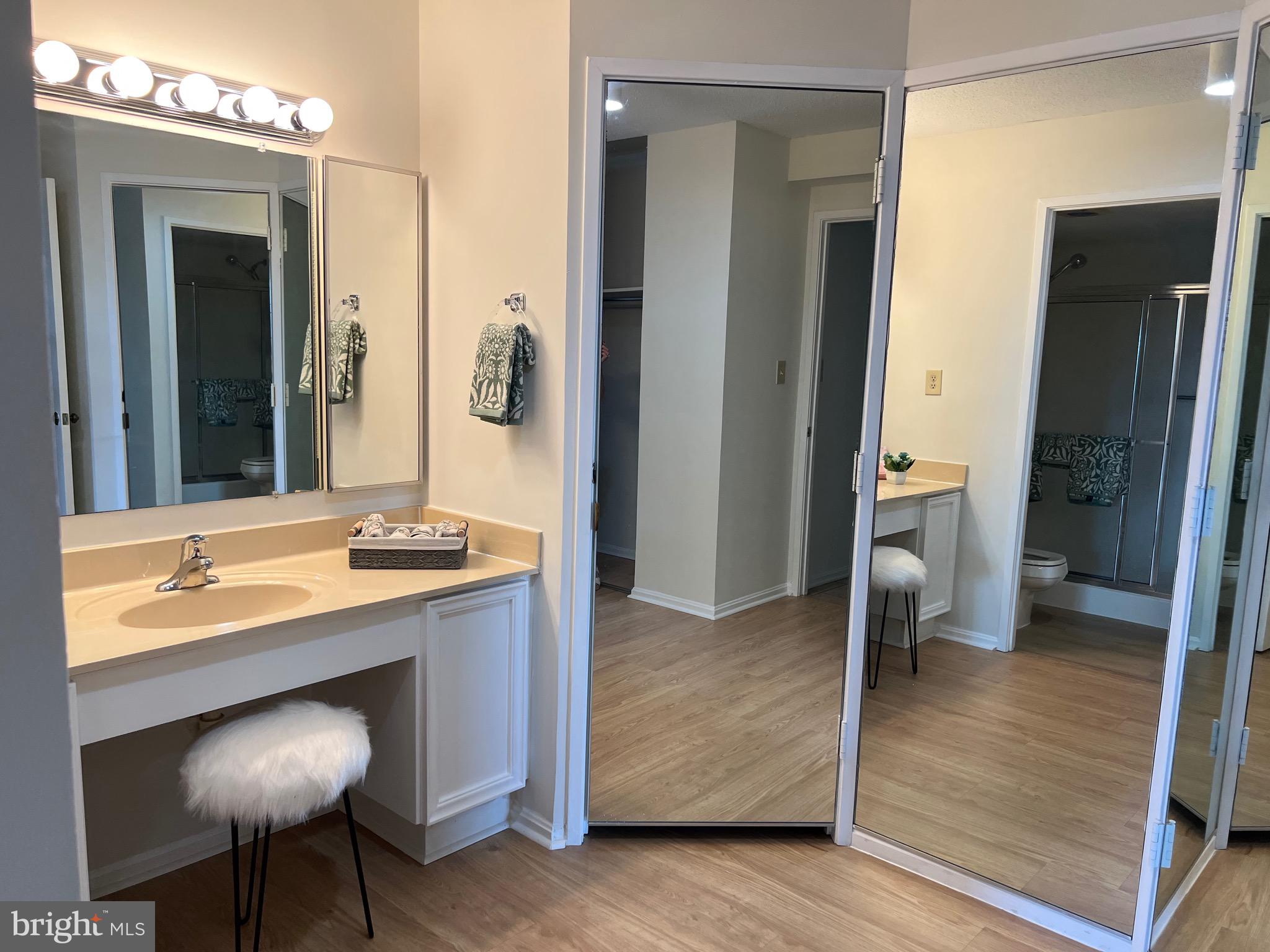 15100 Interlachen Drive, Unit 4709 Silver Spring, MD 20906 - Photo 14 of 22 a spacious bathroom with a sink and a mirror