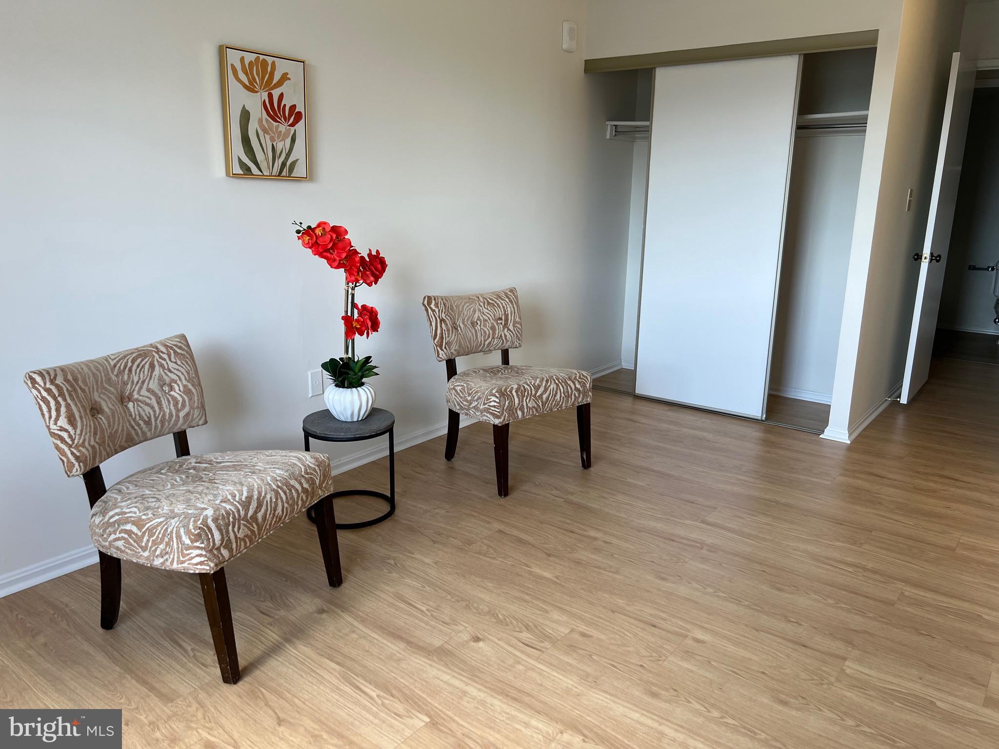 15100 Interlachen Drive, Unit 4709 Silver Spring, MD 20906 - Photo 17 of 22 a living room with furniture and a wooden floor