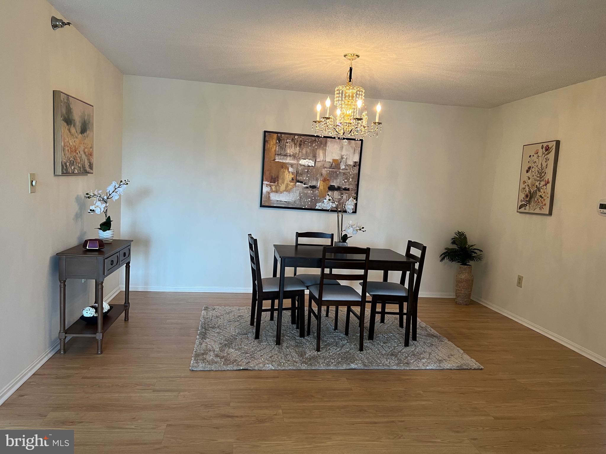 15100 Interlachen Drive, Unit 4709 Silver Spring, MD 20906 - Photo 3 of 22 a view of a dining room with furniture