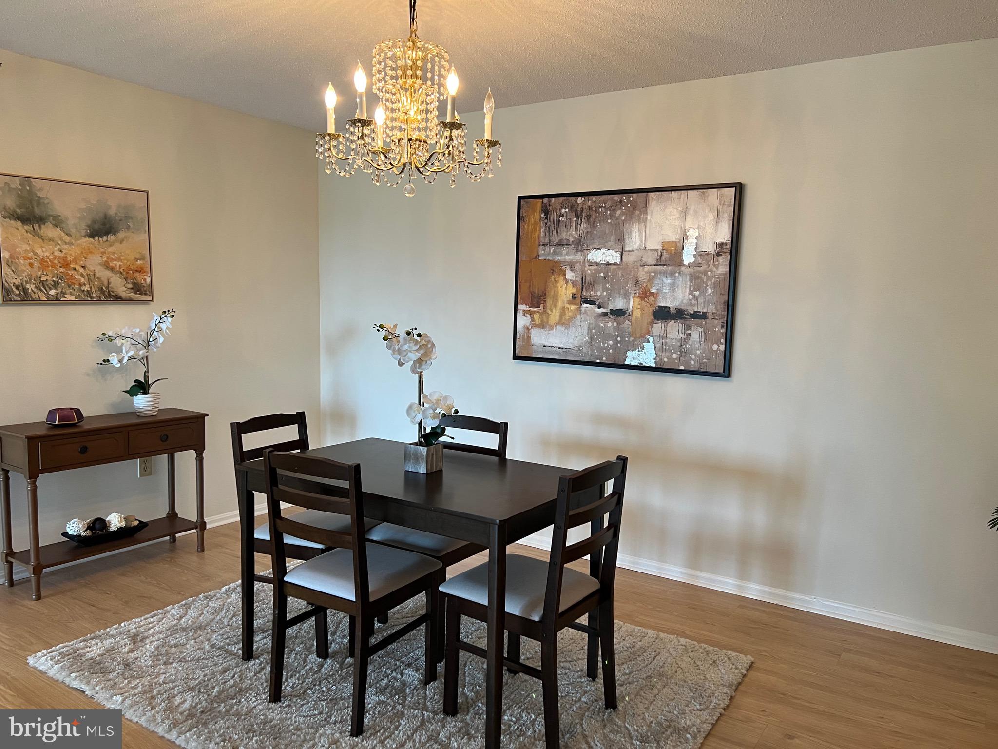 15100 Interlachen Drive, Unit 4709 Silver Spring, MD 20906 - Photo 4 of 22 a view of a dining room with furniture and wooden floor