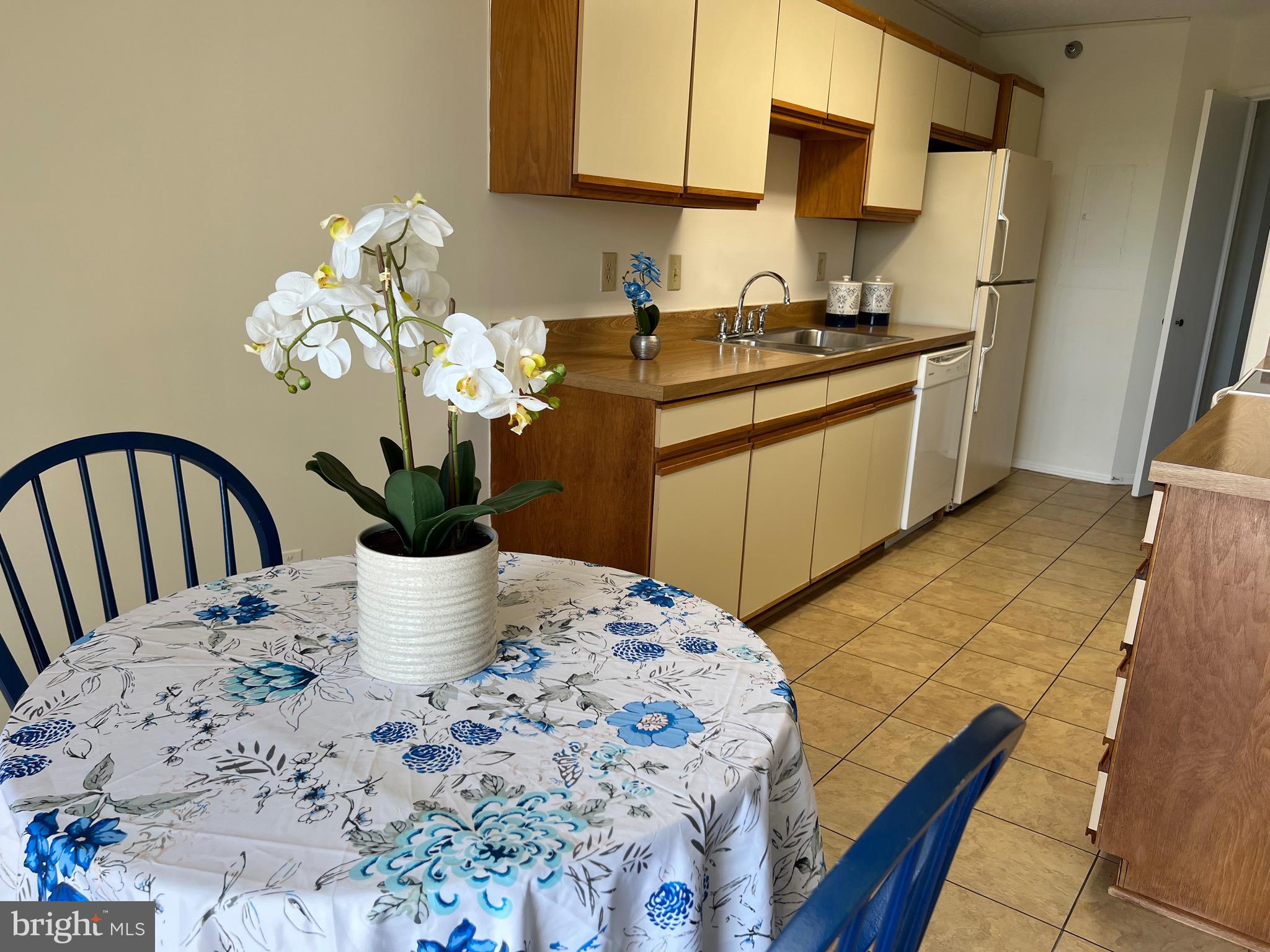 15100 Interlachen Drive, Unit 4709 Silver Spring, MD 20906 - Photo 8 of 22 a kitchen with a table and chairs