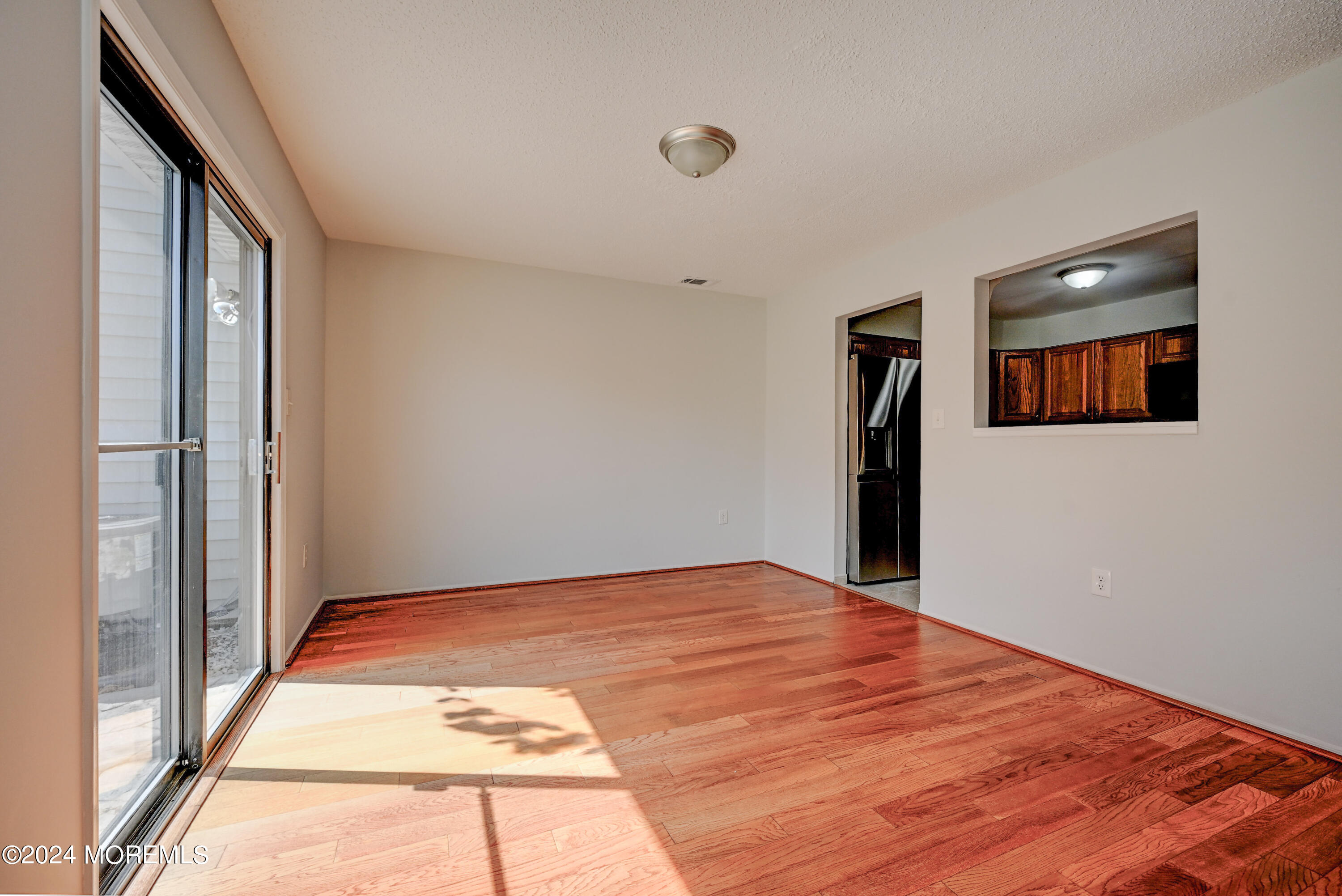 44 Mariners Cove Freehold, NJ 07728 - Photo 18 of 38 a view of an empty room with wooden floor and a window
