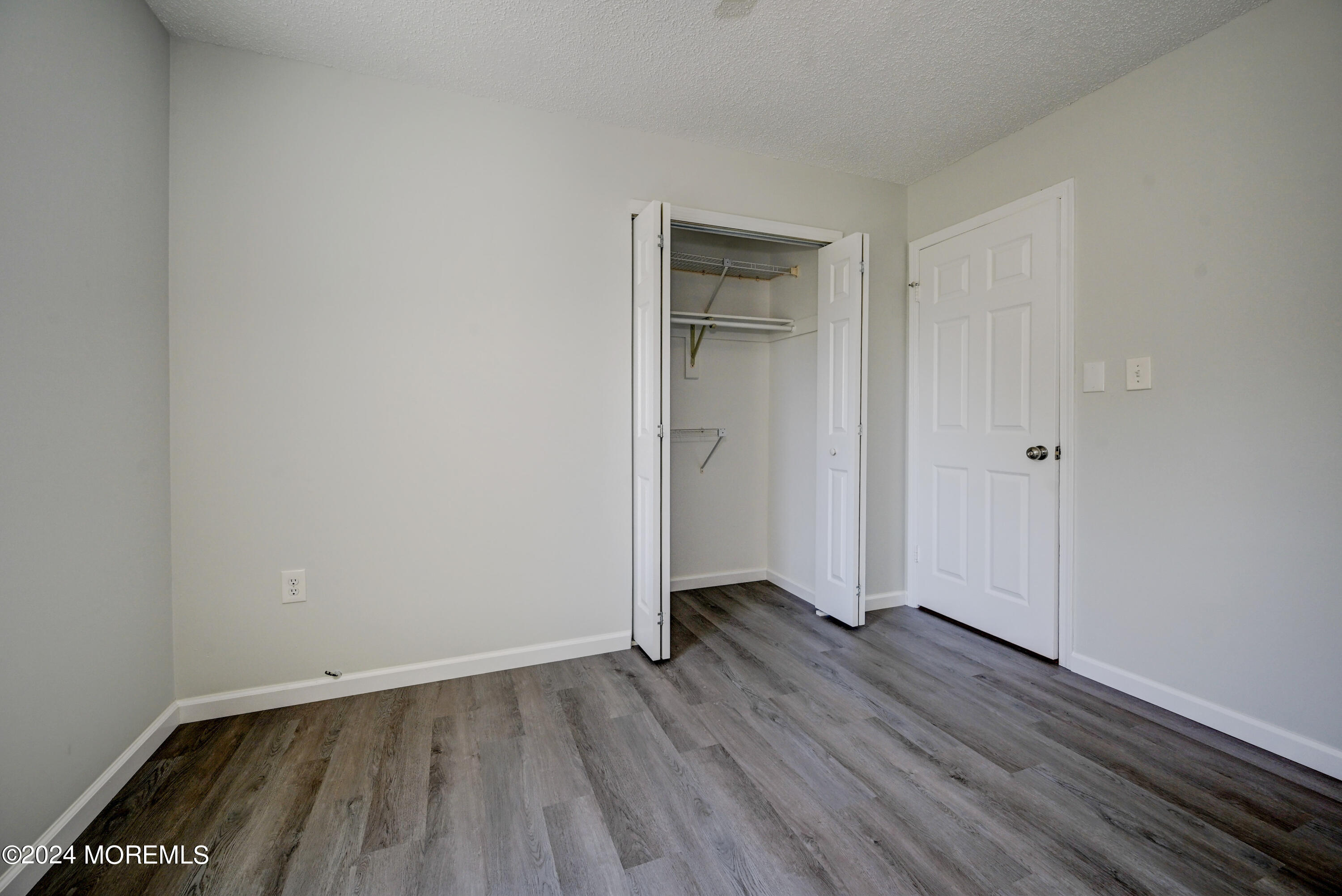 44 Mariners Cove Freehold, NJ 07728 - Photo 23 of 38 a view of an empty room with wooden floor and closet