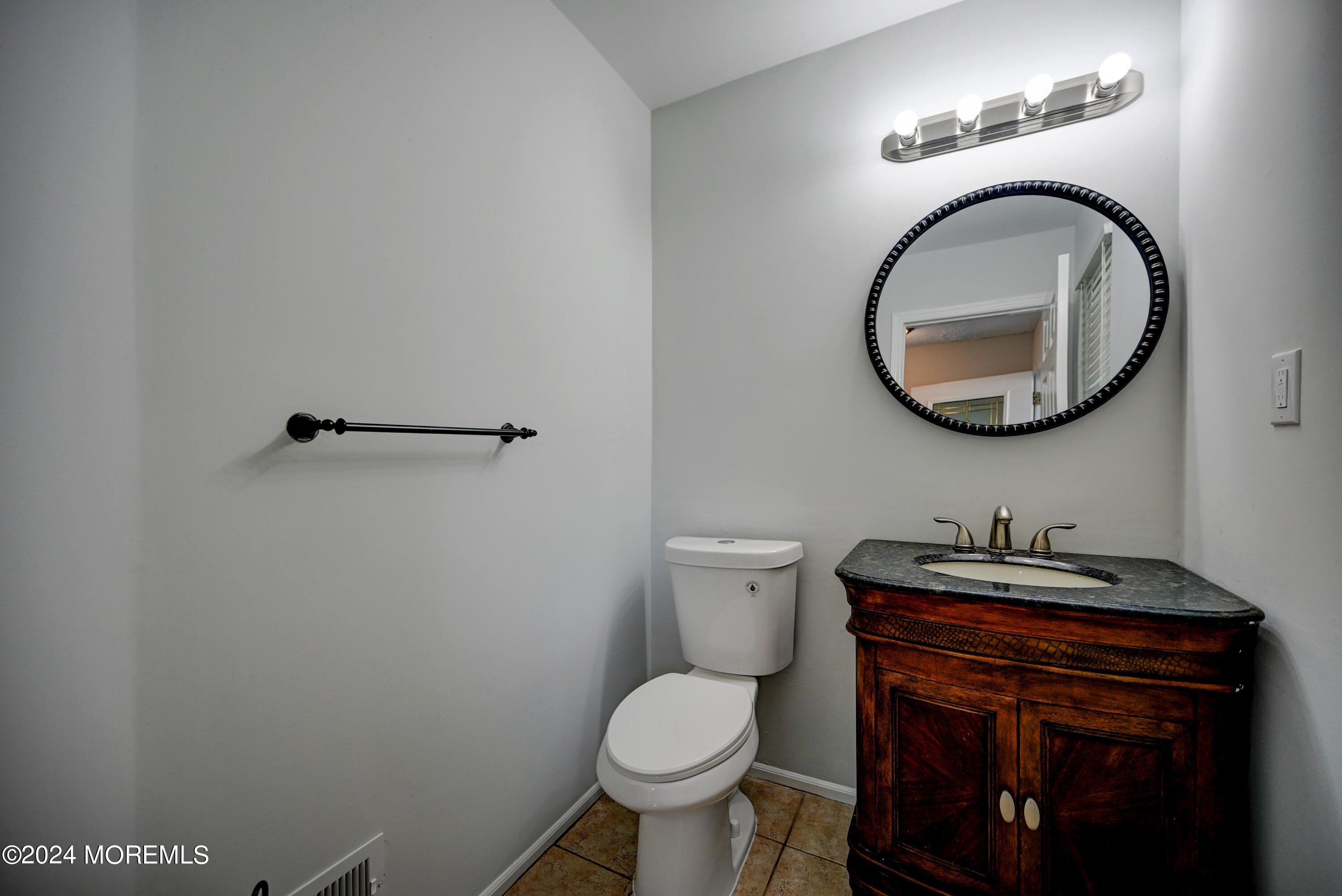 44 Mariners Cove Freehold, NJ 07728 - Photo 27 of 38 a bathroom with a toilet a sink and a mirror
