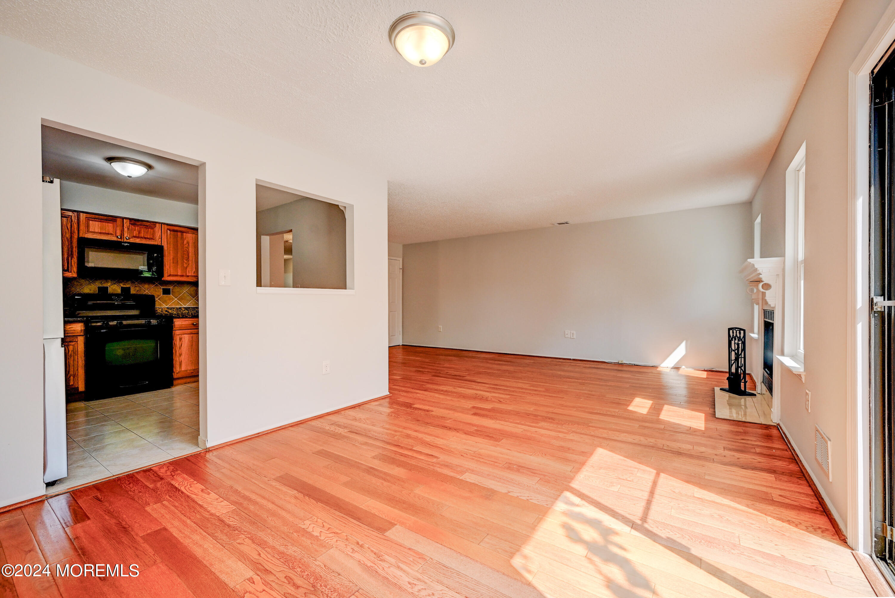 44 Mariners Cove Freehold, NJ 07728 - Photo 9 of 38 a view of empty room with wooden floor and cabinet
