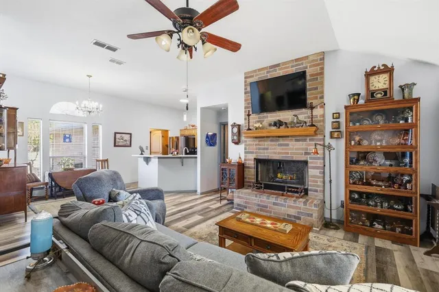 a living room with furniture a flat screen tv and a fireplace