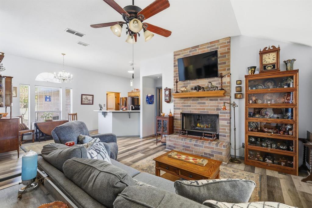 11649 Mitchell Circle Ponder, TX 76259 - Photo 11 of 38 a living room with furniture a flat screen tv and a fireplace