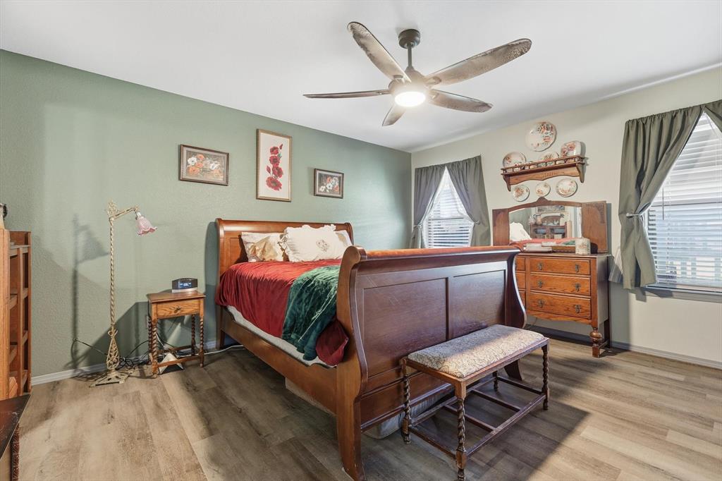 11649 Mitchell Circle Ponder, TX 76259 - Photo 16 of 38 a bedroom with a bed and wooden floor