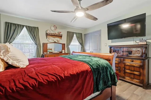 a bedroom with a bed and a flat screen tv