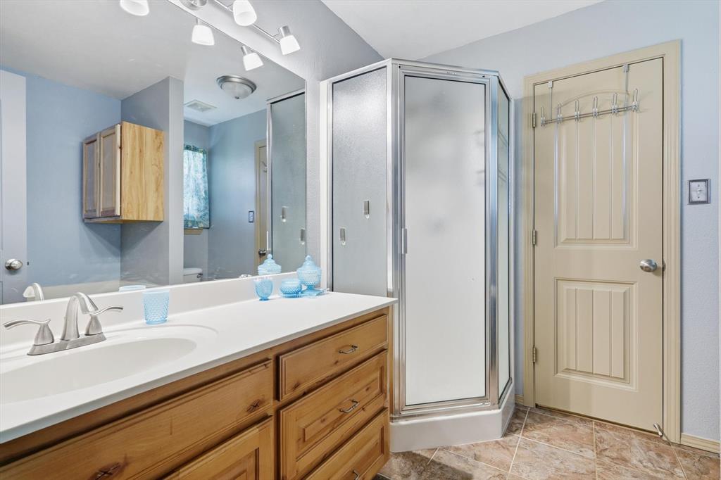 11649 Mitchell Circle Ponder, TX 76259 - Photo 18 of 38 a bathroom with a sink and a mirror