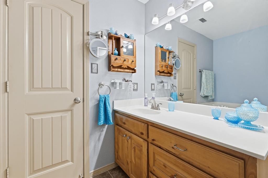 11649 Mitchell Circle Ponder, TX 76259 - Photo 19 of 38 a bathroom with a sink and a mirror