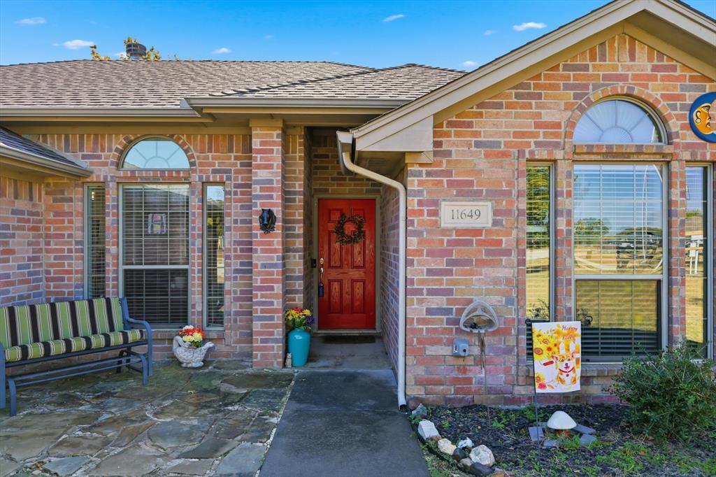 11649 Mitchell Circle Ponder, TX 76259 - Photo 2 of 38 a front view of a house with garden