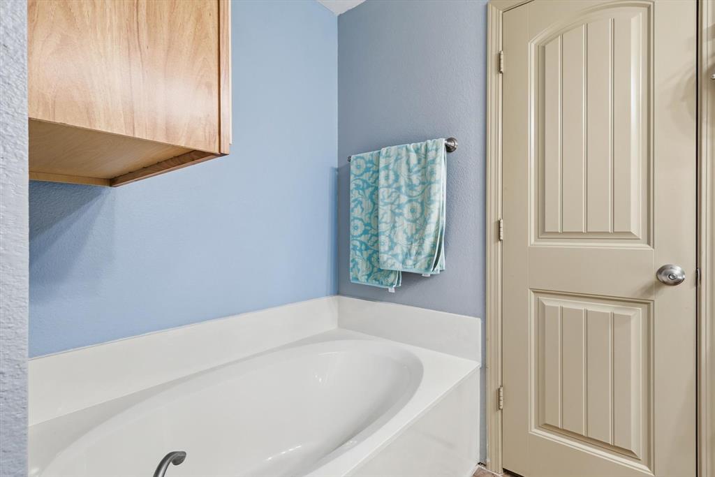11649 Mitchell Circle Ponder, TX 76259 - Photo 23 of 38 a bathroom with a bathtub and shower
