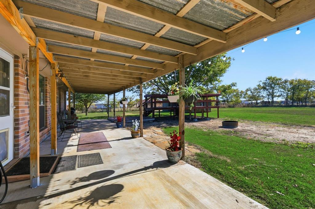 11649 Mitchell Circle Ponder, TX 76259 - Photo 26 of 38 a view of a backyard with sitting area