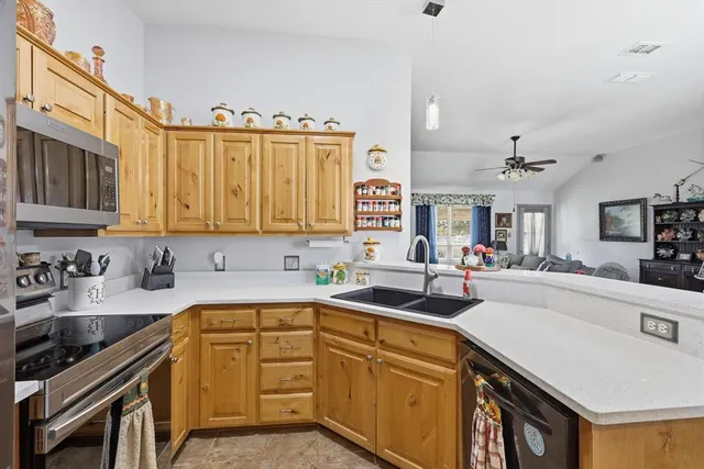 a kitchen with a sink stove top oven and cabinets
