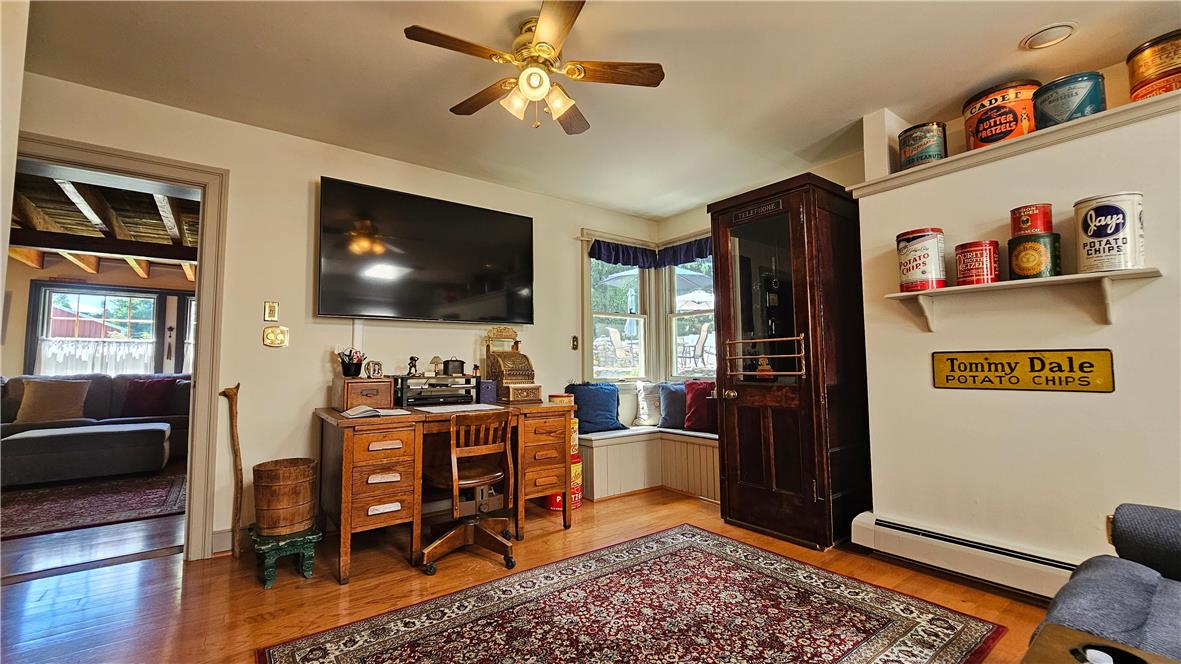 585 Buttermilk Road Hellertown, PA 18055 - Photo 19 of 82 Hardwood floors and a classic ceiling fan elevate this inviting living space.
