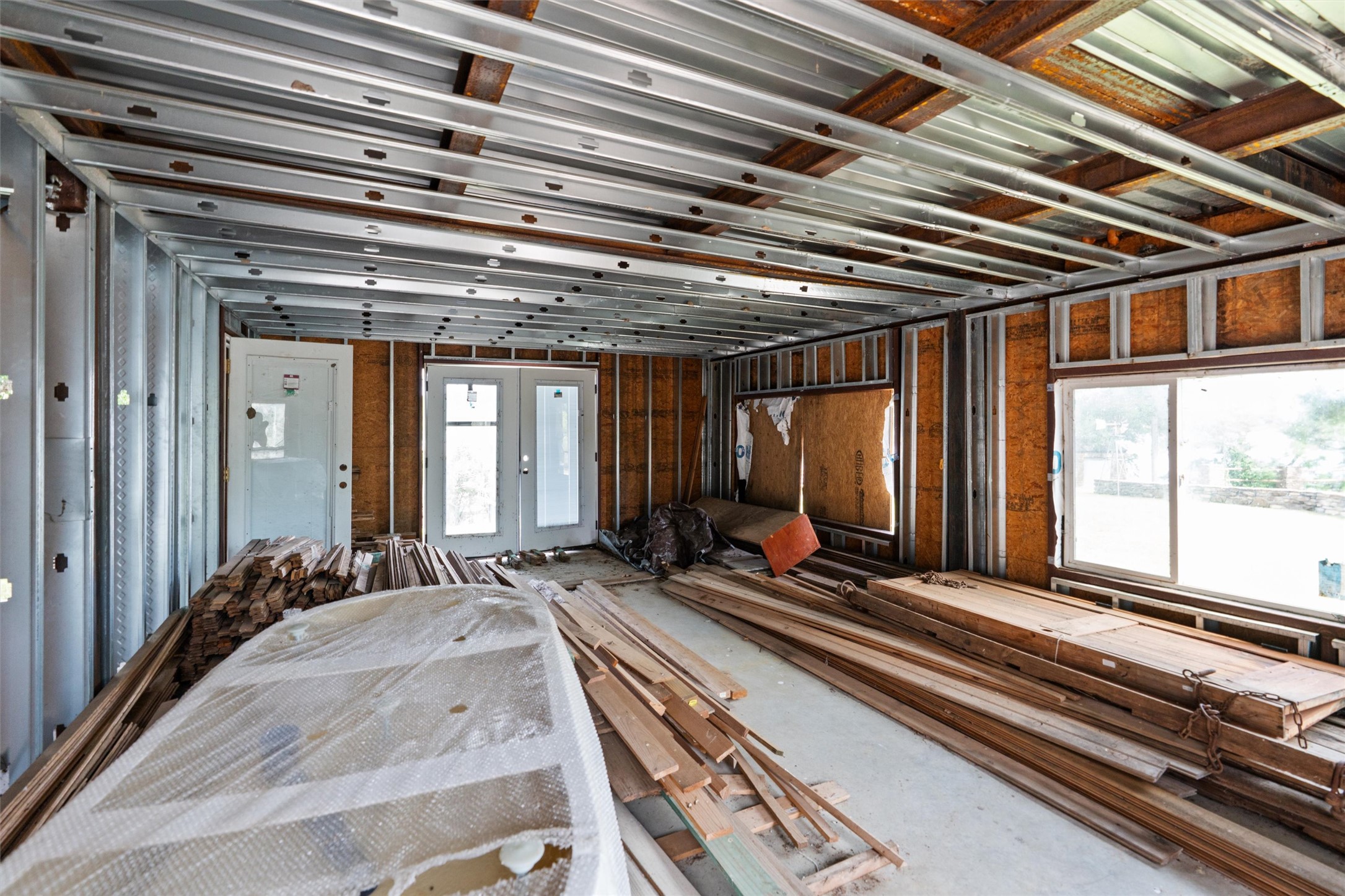 325 Eagle Rest Burnet, TX 78611 - Photo 32 of 40 A promising interior under construction, revealing steel framing and an open layout awaiting customization.