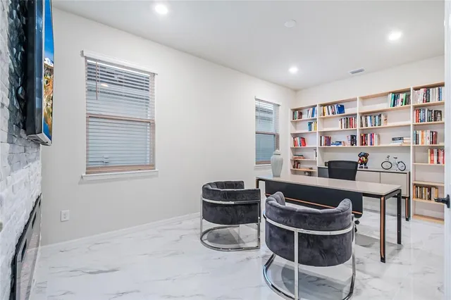 a reading room with furniture and a book shelf