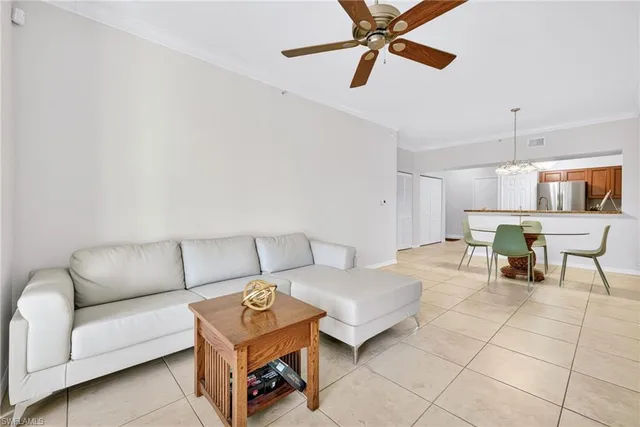 a living room with furniture and a ceiling fan